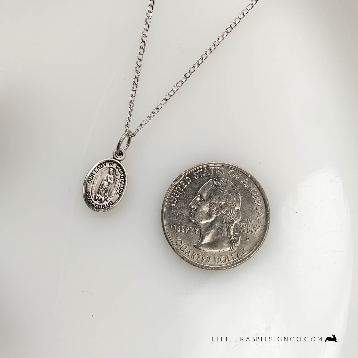 This tiny Our Lady of Guadalupe medal is pictured next to a quarter to show the size of this piece. This delicate necklace is perfect for a confirmation gift for a catholic girl, RCIA gift for a catholic, or just a beautiful gift for her.