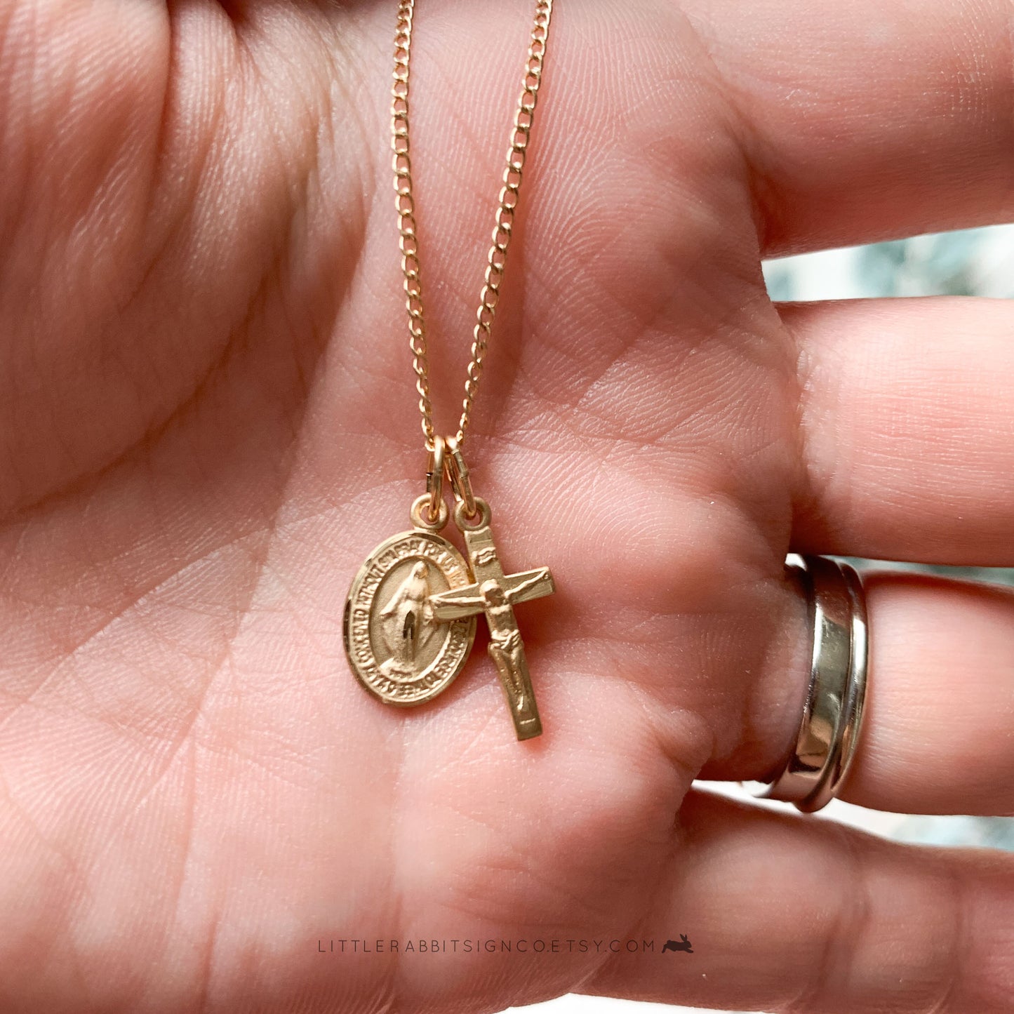 14kt gold filled Miraculous Medal and Crucifix held in a hand for size reference — petite Catholic necklace