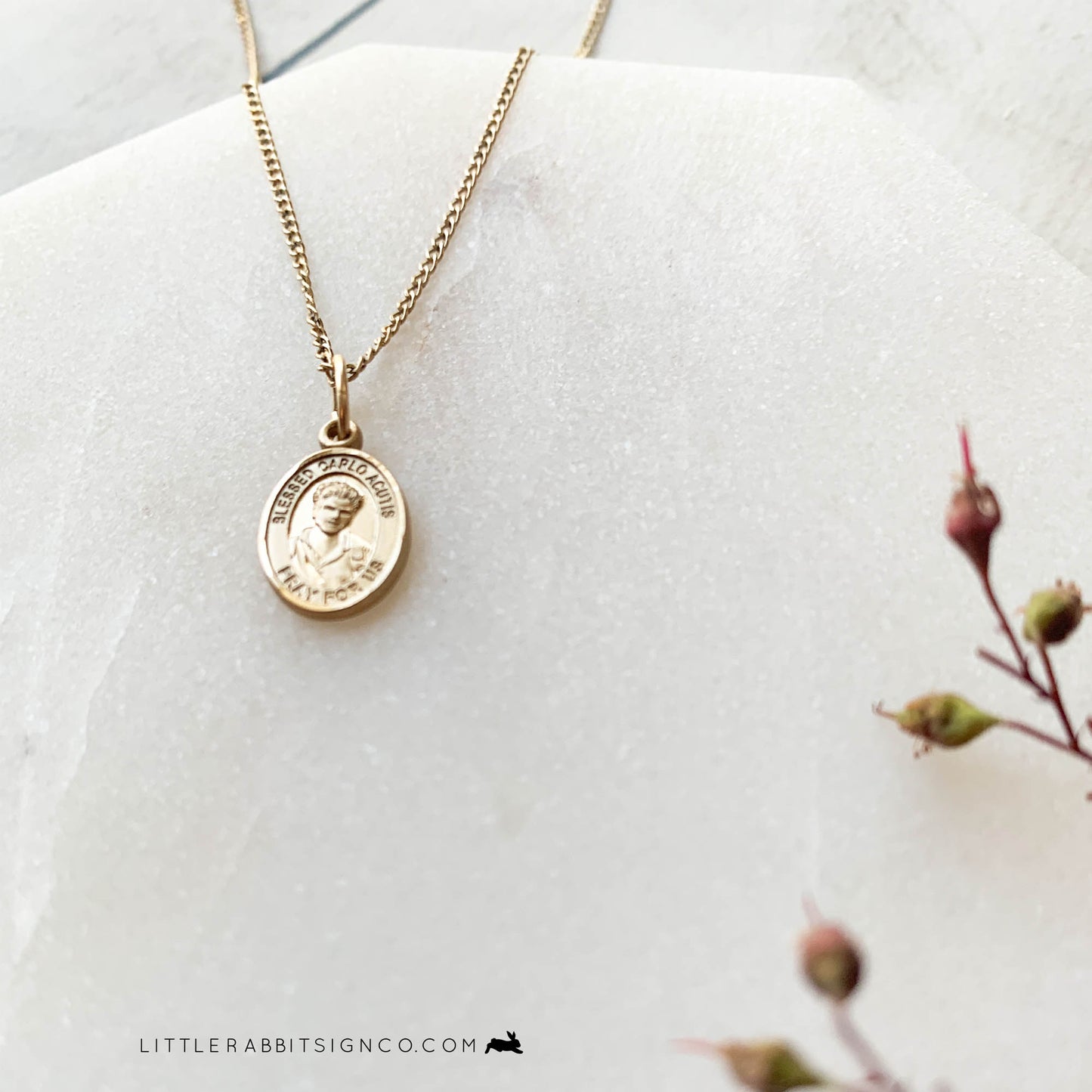 Shown in this image is a side view and shimmer of a Blessed Carlo Acutis necklace. This heirloom necklace is perfect for the young Catholic.