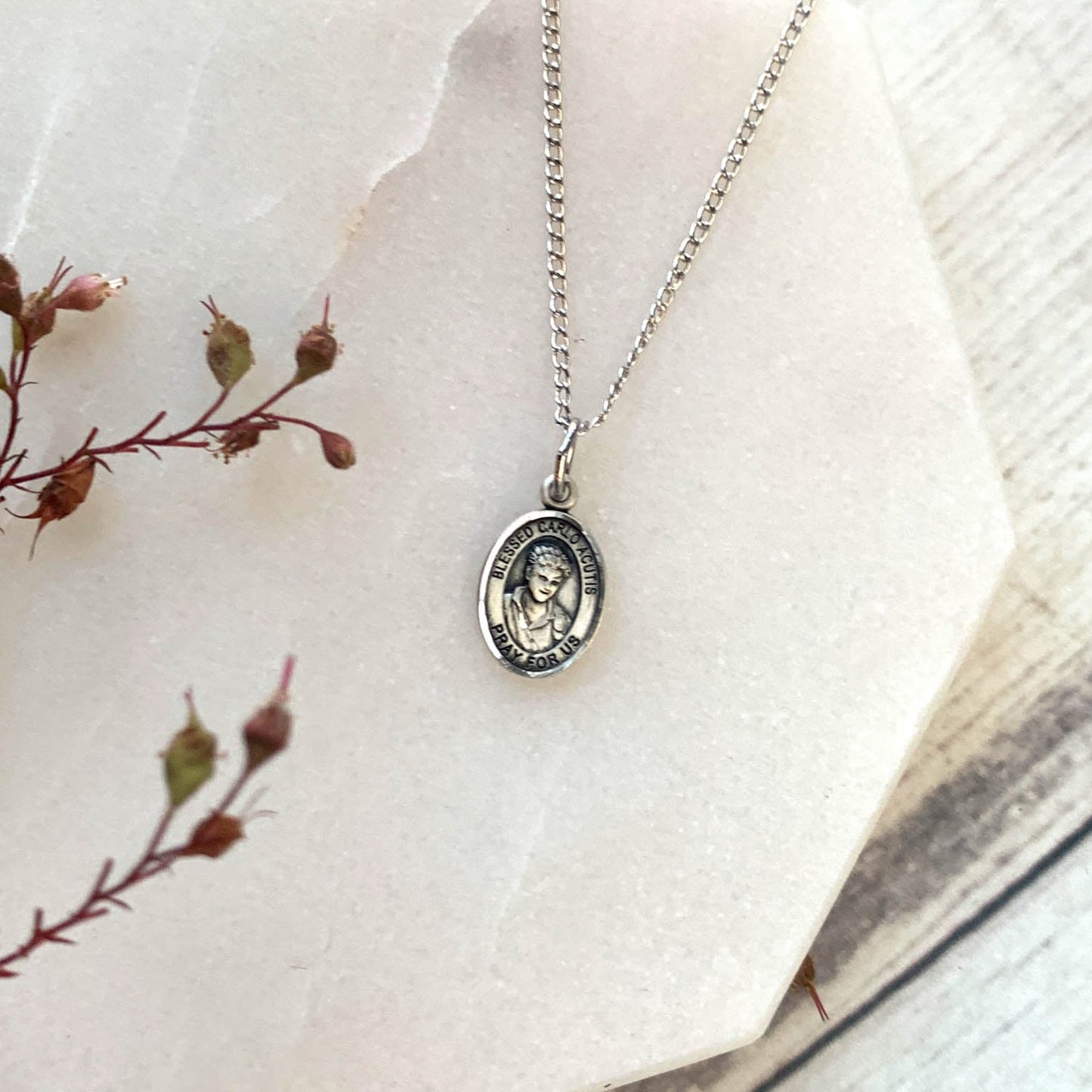 Sterling Silver Blessed Carlo Acutis necklace suspended on a silver chain.