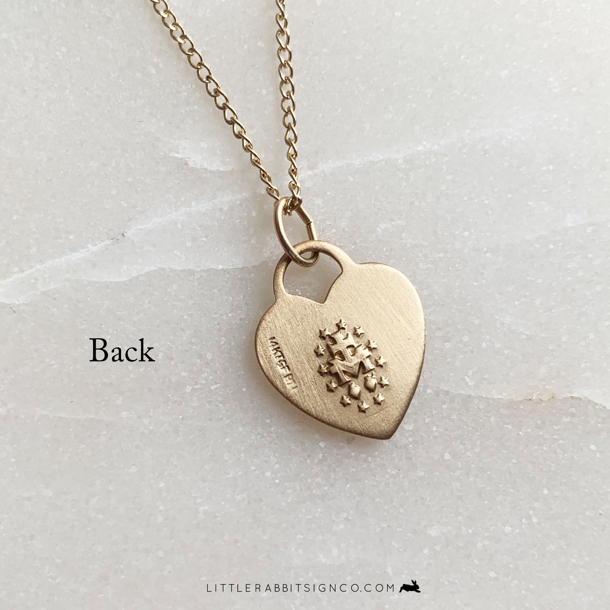 Back of the 14kt gold filled heart Miraculous Medal pendant showing traditional markings