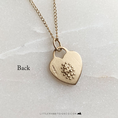 Back of the 14kt gold filled heart Miraculous Medal pendant showing traditional markings