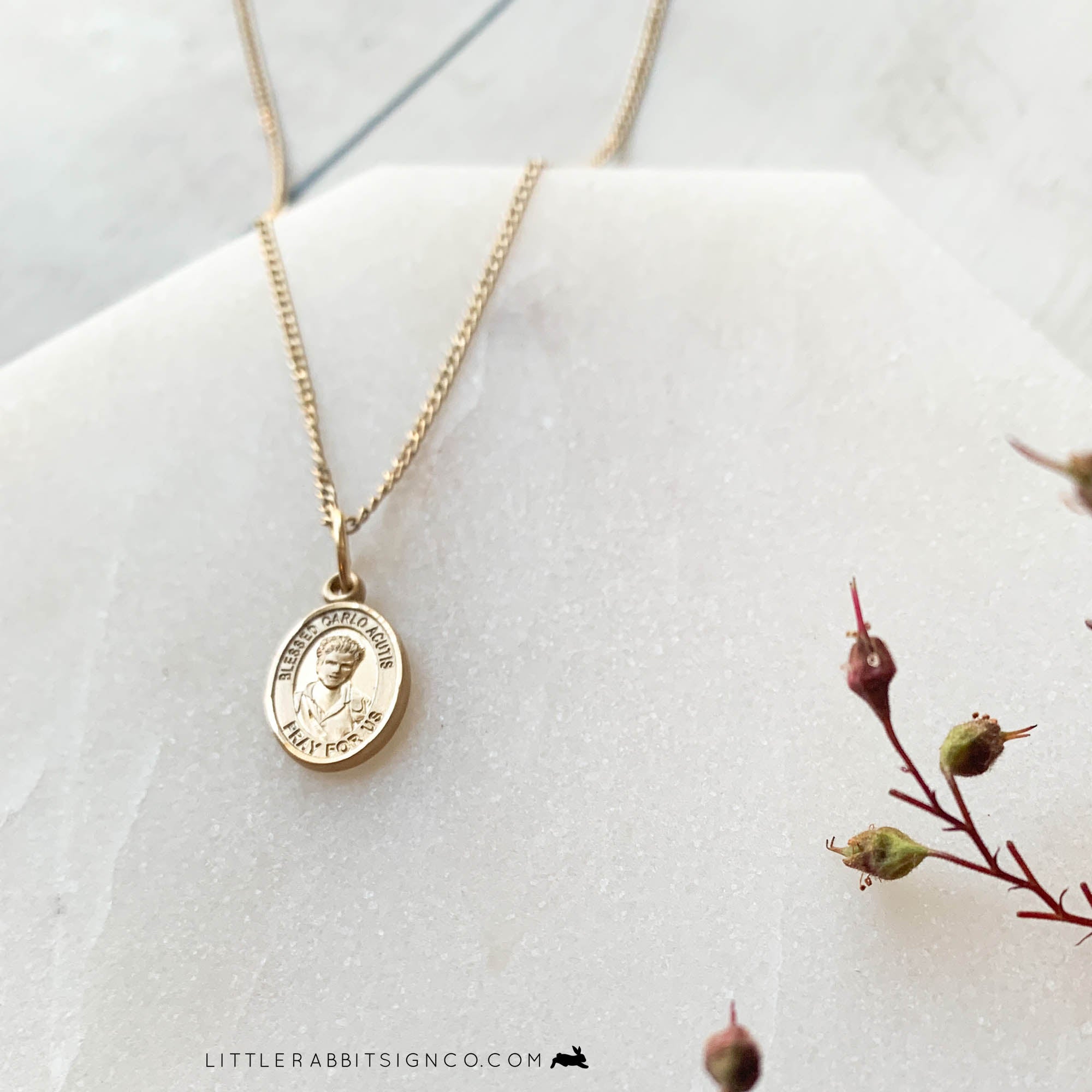 Tiny Gold Filled Saint Carlo Acutis Necklace on a dainty minimalist gold chain. This teen died of leukemia at the age of 15. He loved Jesus and promoted the Real Presence of the Eucharist on the internet. He is the patron of the internet, computer programmers, and youth. This gold necklace is proudly made in the USA. 