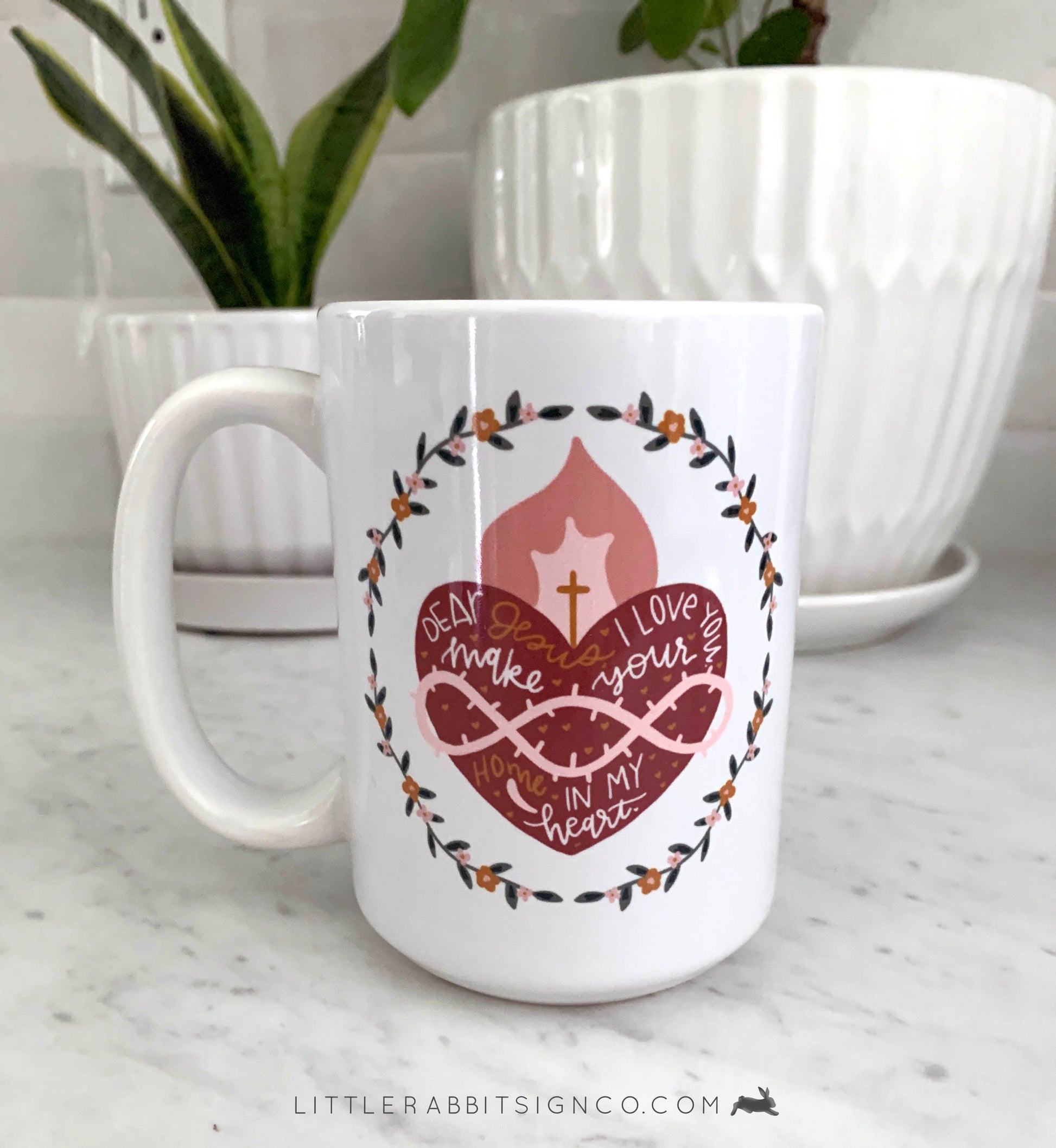 Sacred Heart of Jesus Coffee Mug with a Hand drawn illustration of Jesus' Sacred Heart with a white glossy background. Text reads "Dear Jesus, I love you. Make your home in my heart."