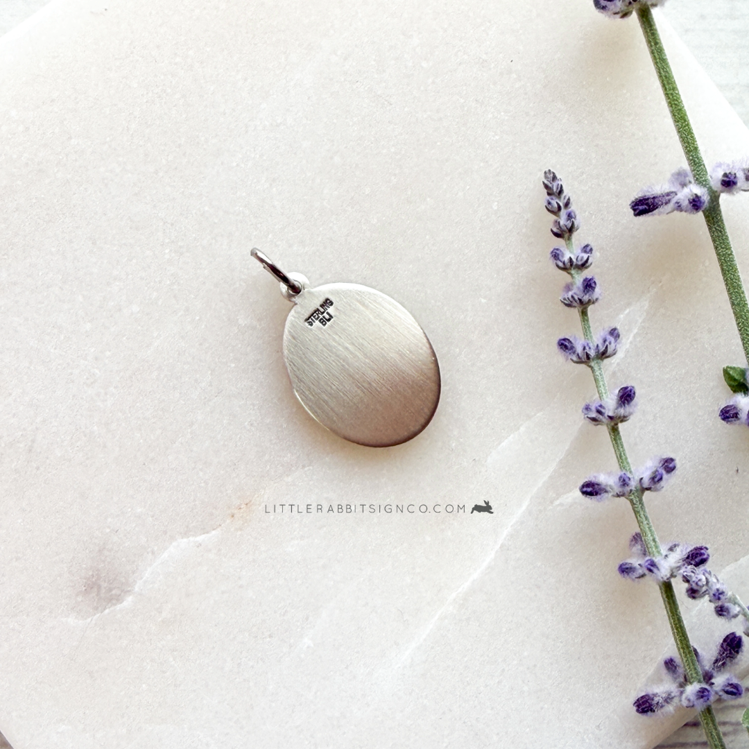 Back view of a Sterling silver Saint Thérèse of Lisieux medal — meaningful Catholic gift for her