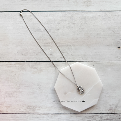 Saint Thérèse of Lisieux sterling silver medal necklace lifestyle shot — Catholic gift for her