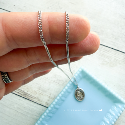 Sterling silver Saint Christopher medal necklace detail shot — patron saint of travelers jewelry